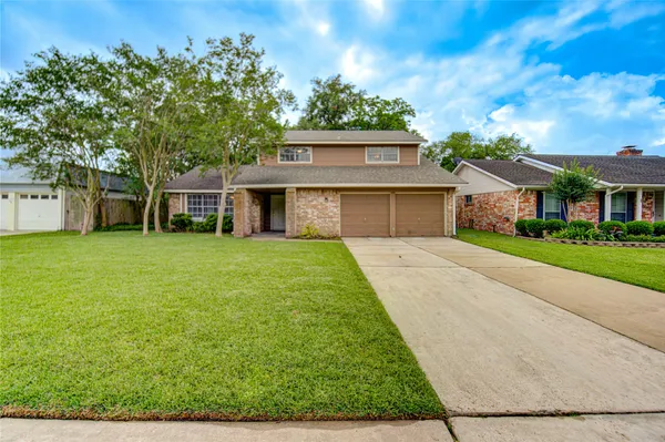 a view of house that has a yard