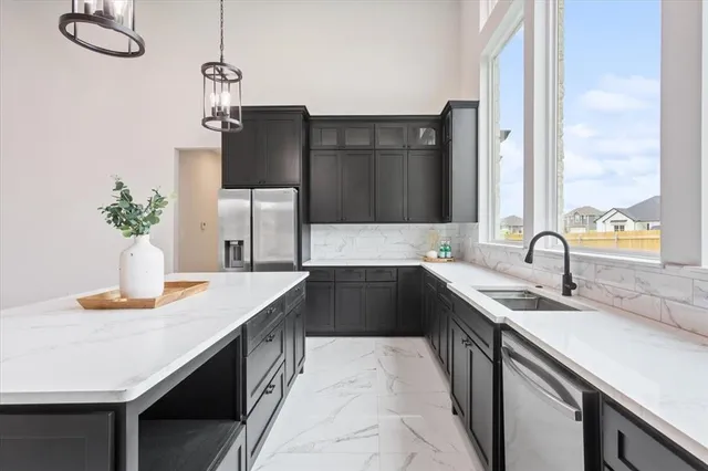 a kitchen with a sink and a refrigerator