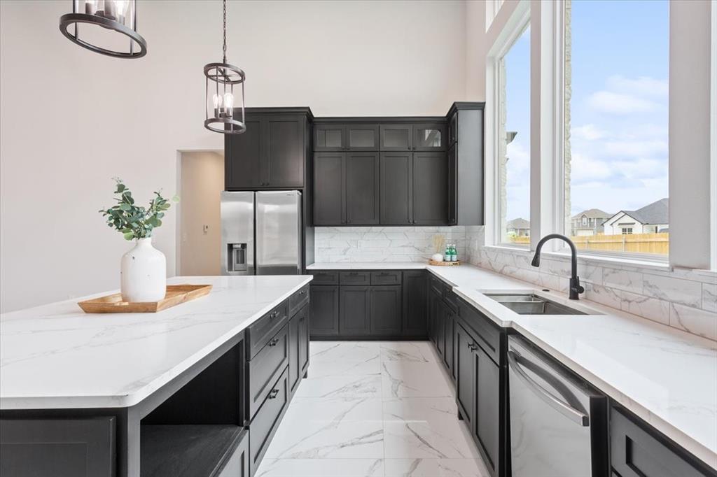 959 Gallant Fox Hewitt, TX 76643 - Photo 12 of 38 a kitchen with a sink and a refrigerator