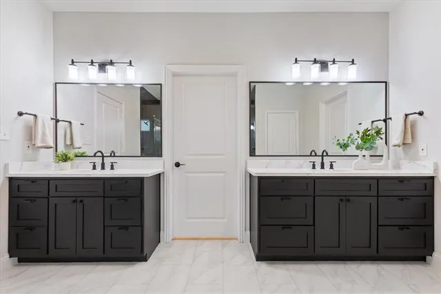 a bathroom with a double vanity sink and a mirror