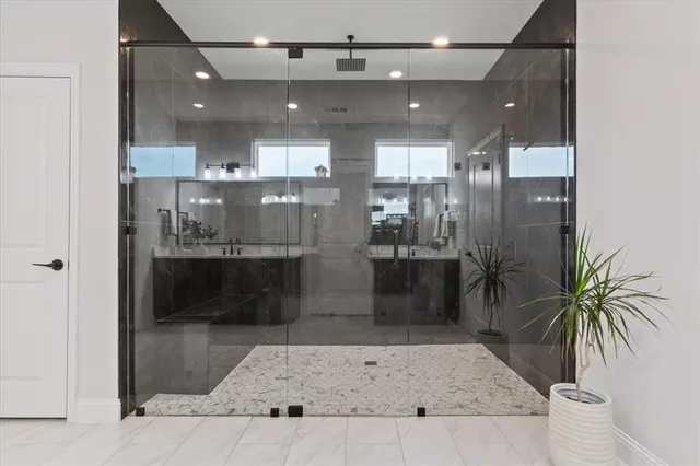 a bathroom with a glass shower door