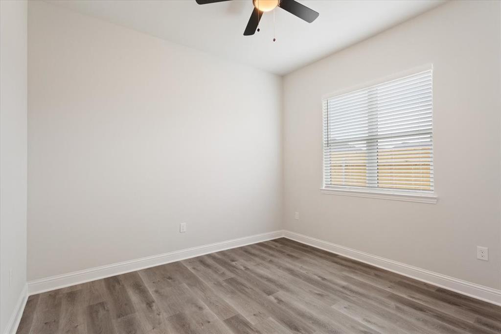 959 Gallant Fox Hewitt, TX 76643 - Photo 23 of 38 an empty room with a window and ceiling fan