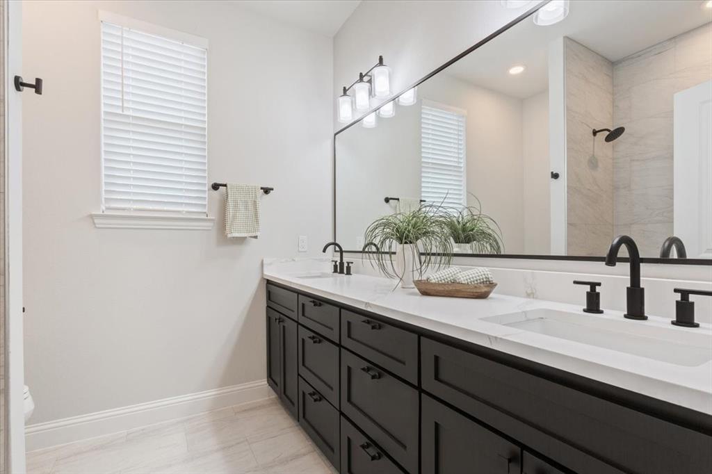 959 Gallant Fox Hewitt, TX 76643 - Photo 24 of 38 a bathroom with a double vanity sink and a mirror