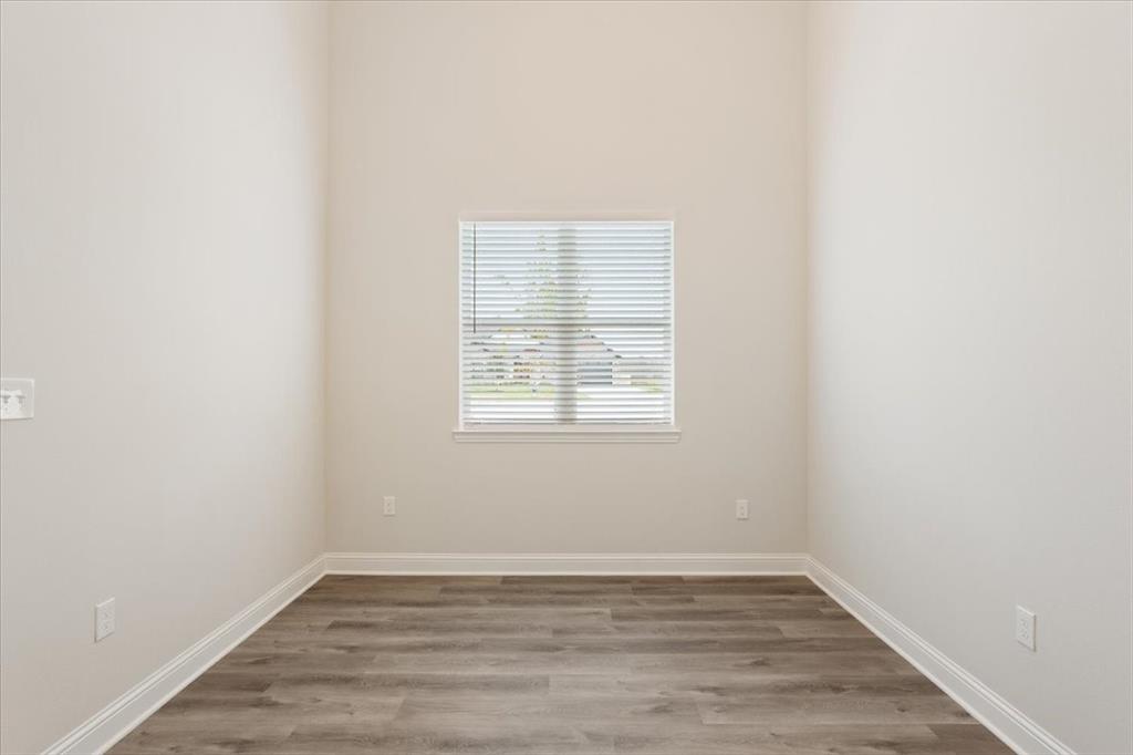 959 Gallant Fox Hewitt, TX 76643 - Photo 27 of 38 an empty room with wooden floor and windows