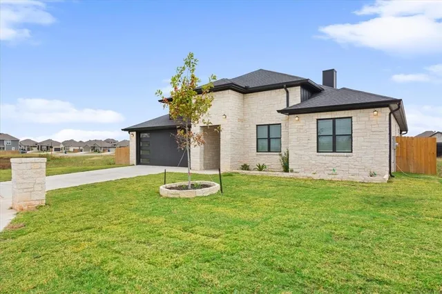 a front view of a house with garden