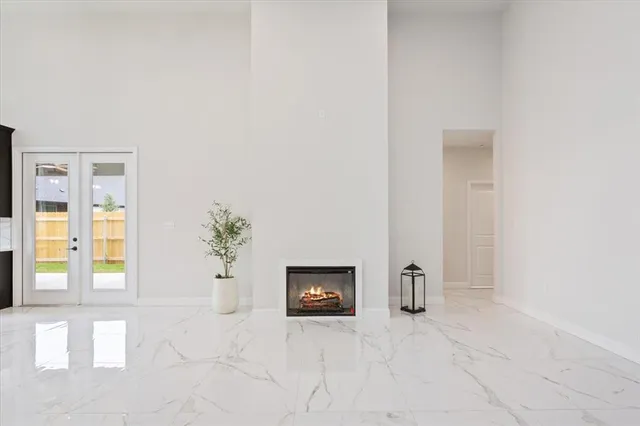 an empty room with windows and cabinet