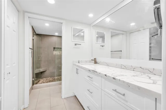a bathroom with a granite countertop sink mirror and double