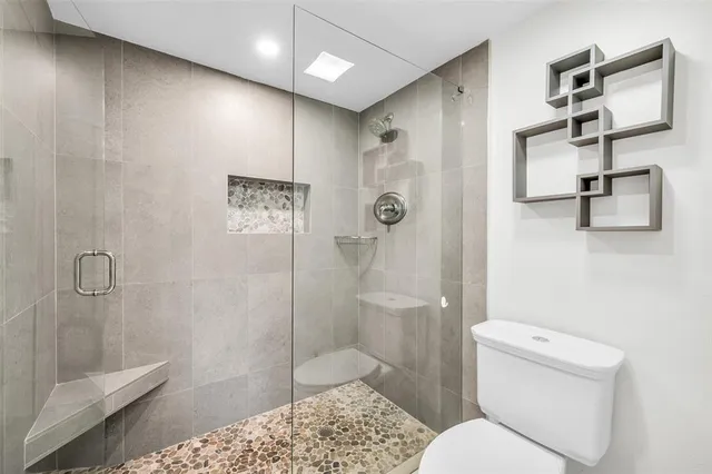 a bathroom with a shower toilet and sink