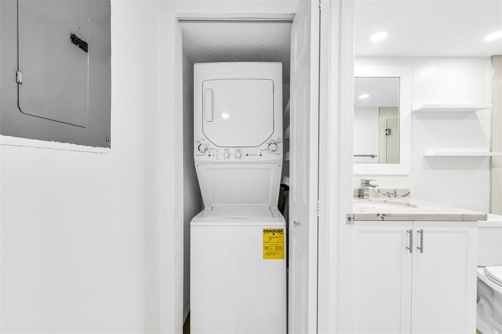 1703 Andros Isle, Unit G4 Coconut Creek, FL 33066 - Photo 15 of 33 a bathroom with a sink a toilet and mirror