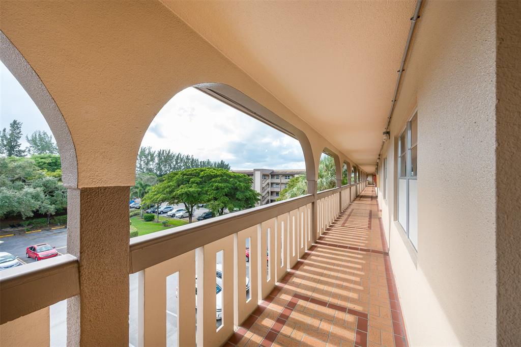 1703 Andros Isle, Unit G4 Coconut Creek, FL 33066 - Photo 18 of 33 a view of a glass door and a balcony