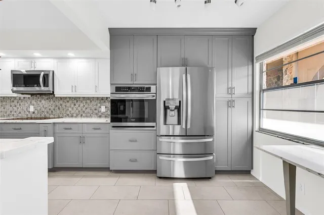 a kitchen with stainless steel appliances and cabinets