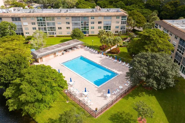 an aerial view of a house with a garden and swimming pool