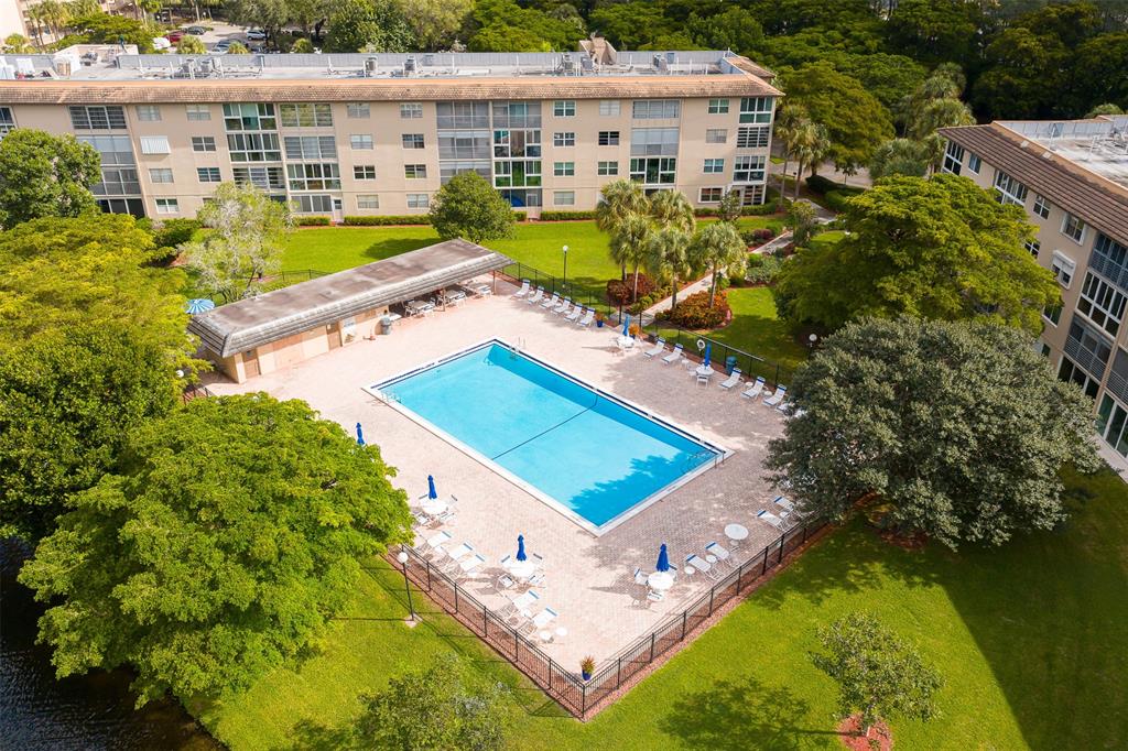 1703 Andros Isle, Unit G4 Coconut Creek, FL 33066 - Photo 24 of 33 an aerial view of a house with a garden and swimming pool