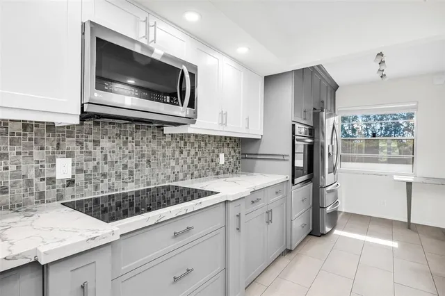 a kitchen with a sink stove and microwave