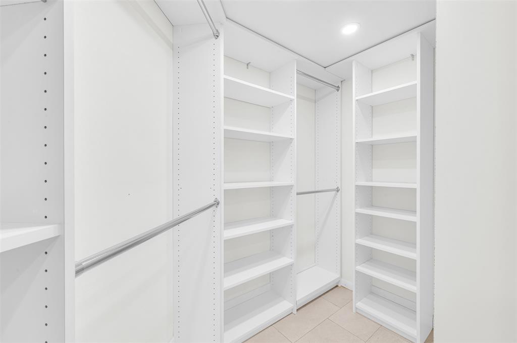 1703 Andros Isle, Unit G4 Coconut Creek, FL 33066 - Photo 10 of 33 a view of walk in closet with empty racks