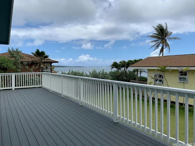 a view of balcony with wooden floor and fence