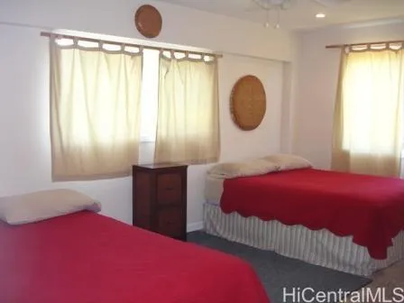 a bedroom with a large bed and a large window