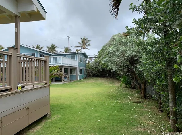 a view of a house with a yard and sitting area