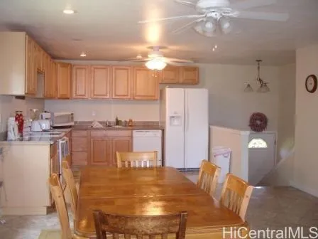 a kitchen with stainless steel appliances granite countertop a refrigerator a stove a microwave oven a sink with island and chairs