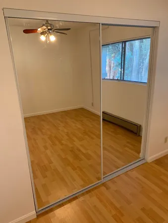 a view of a room with wooden floor and windows