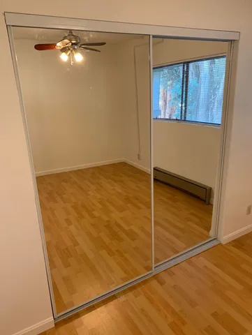 a view of a room with wooden floor and windows