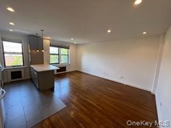 102-12 65th Avenue, Unit 43C Queens, NY 11375 - Photo 15 of 15 a living room with hard wood floors and a kitchen