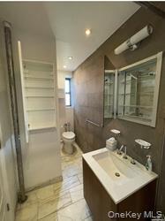 102-12 65th Avenue, Unit 43C Queens, NY 11375 - Photo 6 of 15 a bathroom with a sink toilet and shower