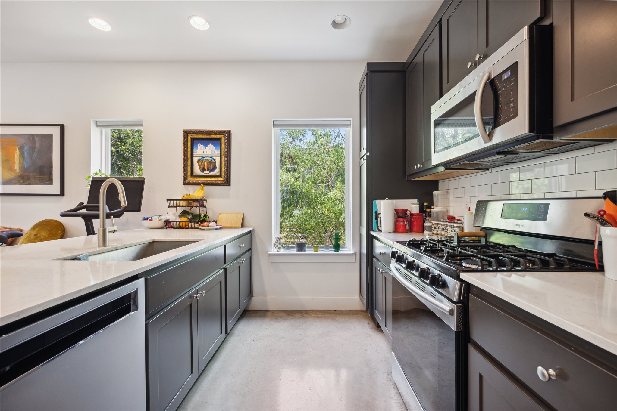 5006 Baker Street, Unit B Austin, TX 78721 - Photo 8 of 16 a kitchen with stainless steel appliances a stove a sink and a microwave