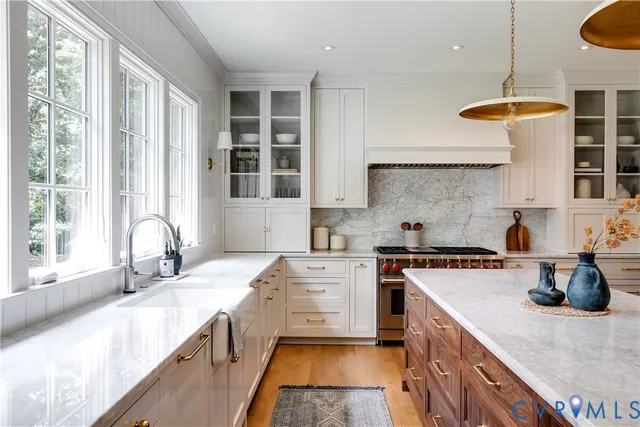 a kitchen with a sink stove and cabinets