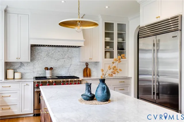 a kitchen with stainless steel appliances granite countertop a refrigerator and a stove