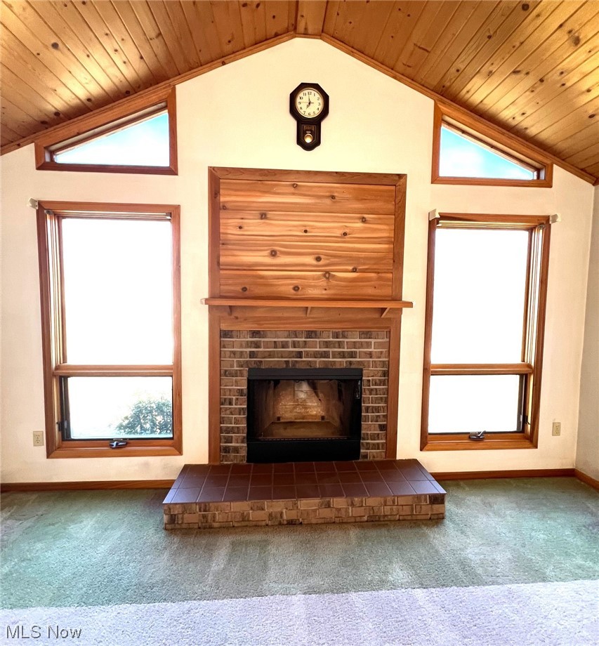 46292 Cedar Way Rogers, OH 44455 - Photo 4 of 12 A close up of fireplace, a healthy amount of sunlight, wooden ceiling, and dark carpet