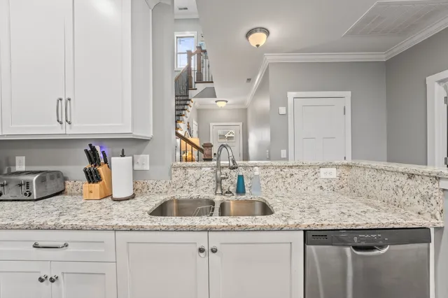 a kitchen with granite countertop a sink and cabinets