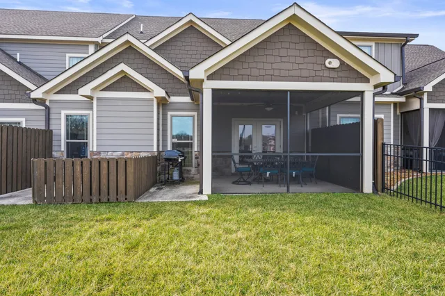 a view of a house with a yard and porch