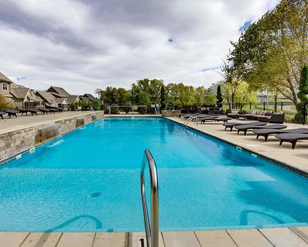 a view of a swimming pool with a table and chairs