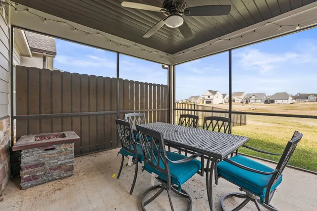 a view of a chairs and table on the roof deck