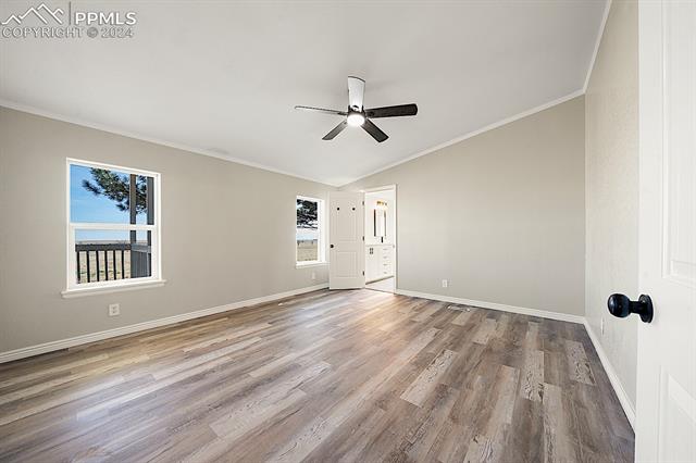 8160 Edison Road Yoder, CO 80864 - Photo 20 of 42 Unfurnished room featuring light hardwood / wood-style flooring, ceiling fan, lofted ceiling, and ornamental molding