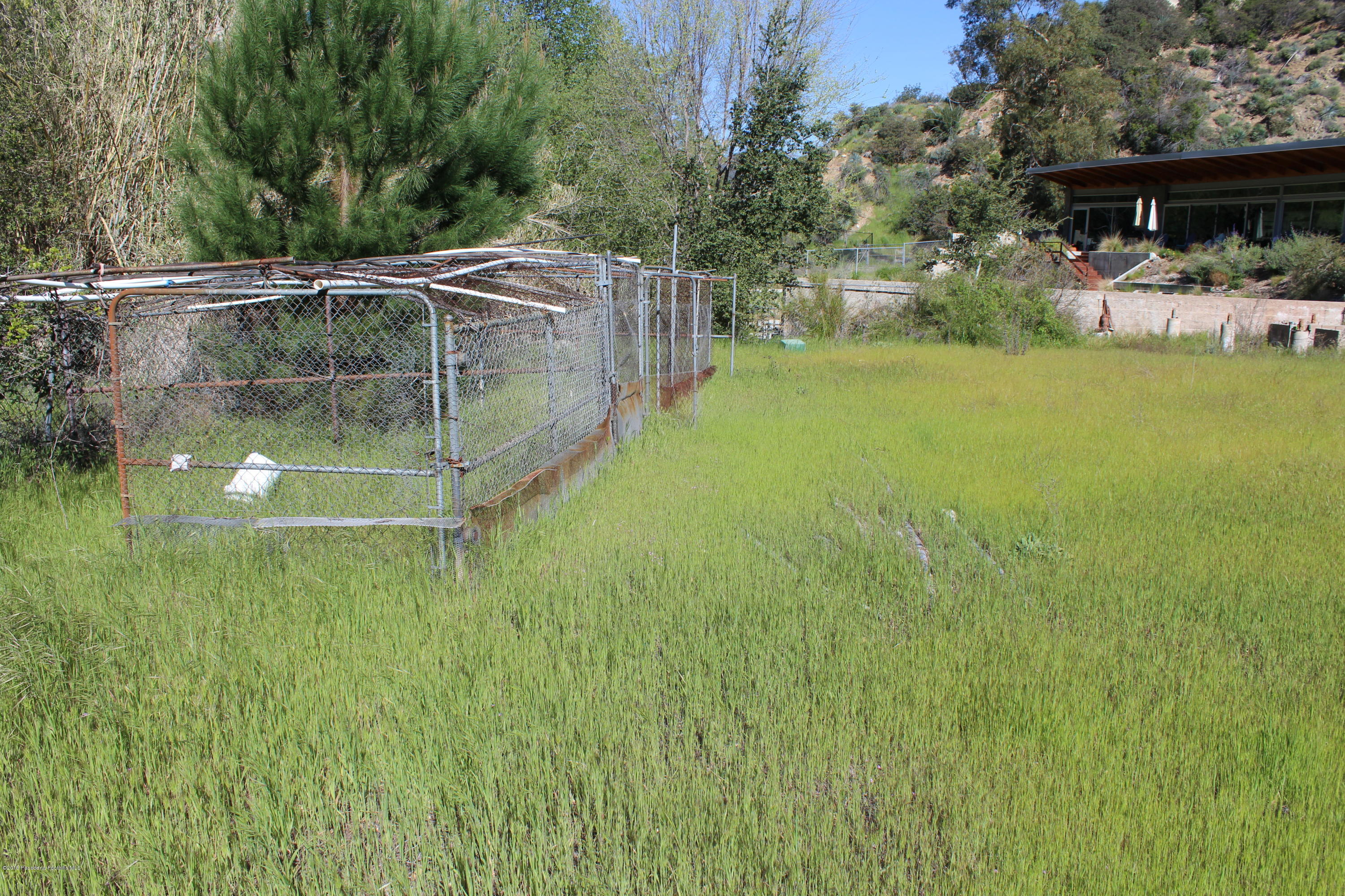 2300 Stonyvale Road Tujunga, CA 91042 - Photo 13 of 15 a backyard of a house with table and chairs and potted plants