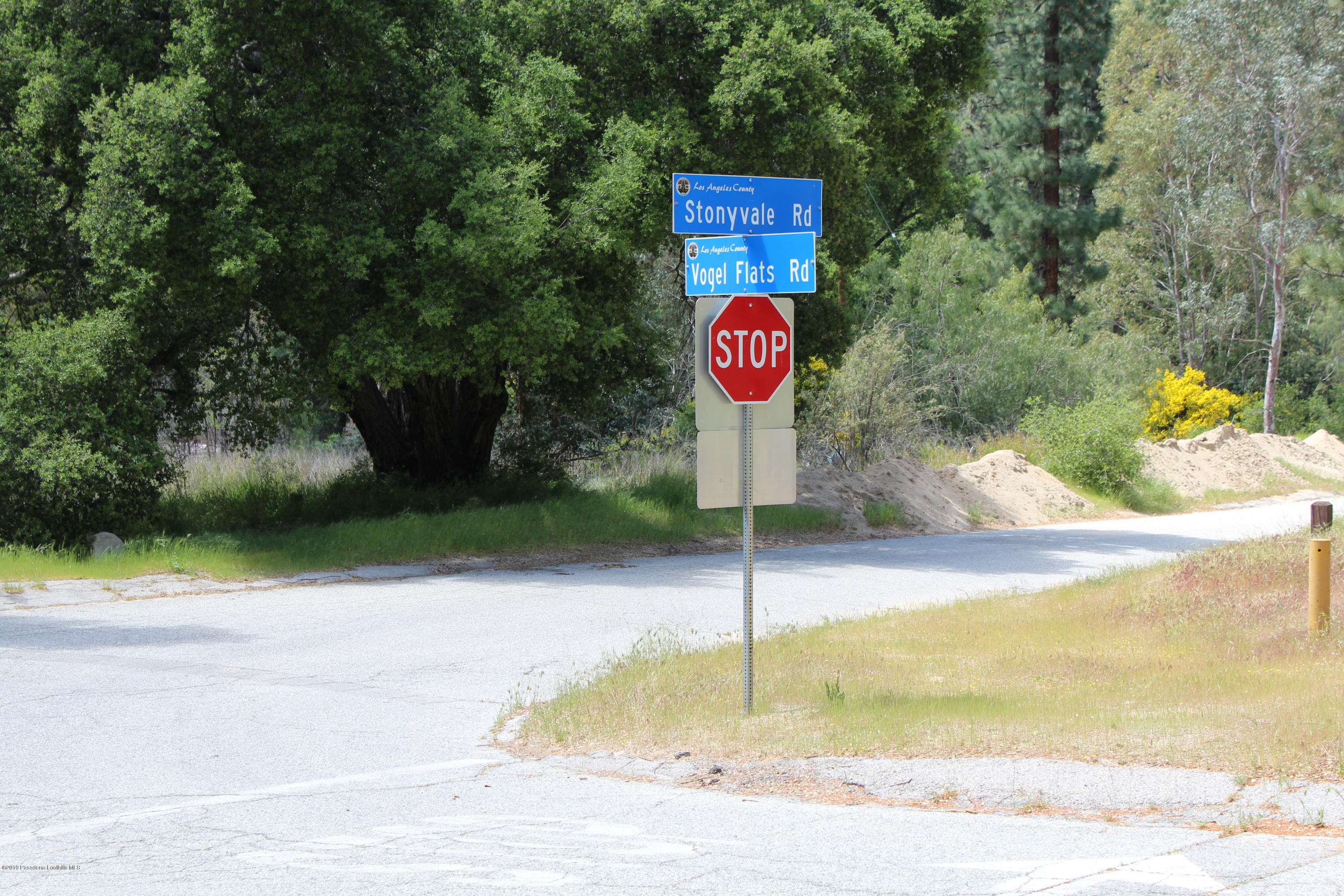 2300 Stonyvale Road Tujunga, CA 91042 - Photo 4 of 15 a view of a street with fire pit and trees in the background