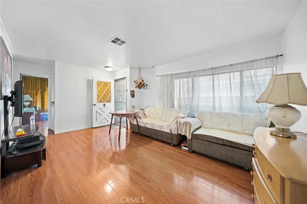 a bedroom with furniture and a wooden floor