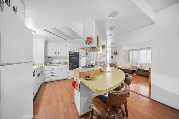 a dining room with furniture and wooden floor