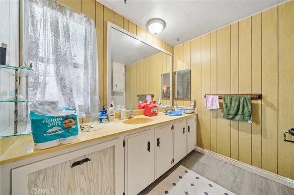a bathroom with a double vanity sink and a mirror