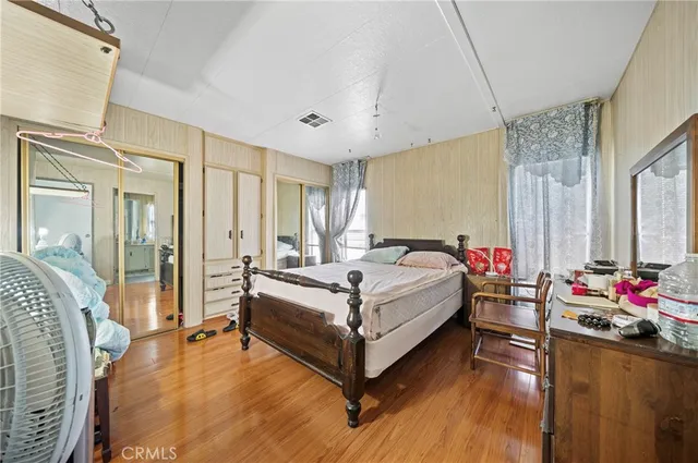 a spacious bedroom with a bed and a chandelier