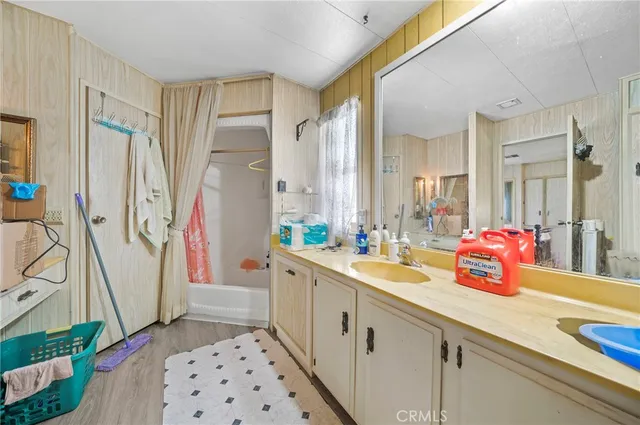 a bathroom with a sink a mirror and a shower