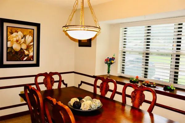 a view of a dining room with furniture and a window