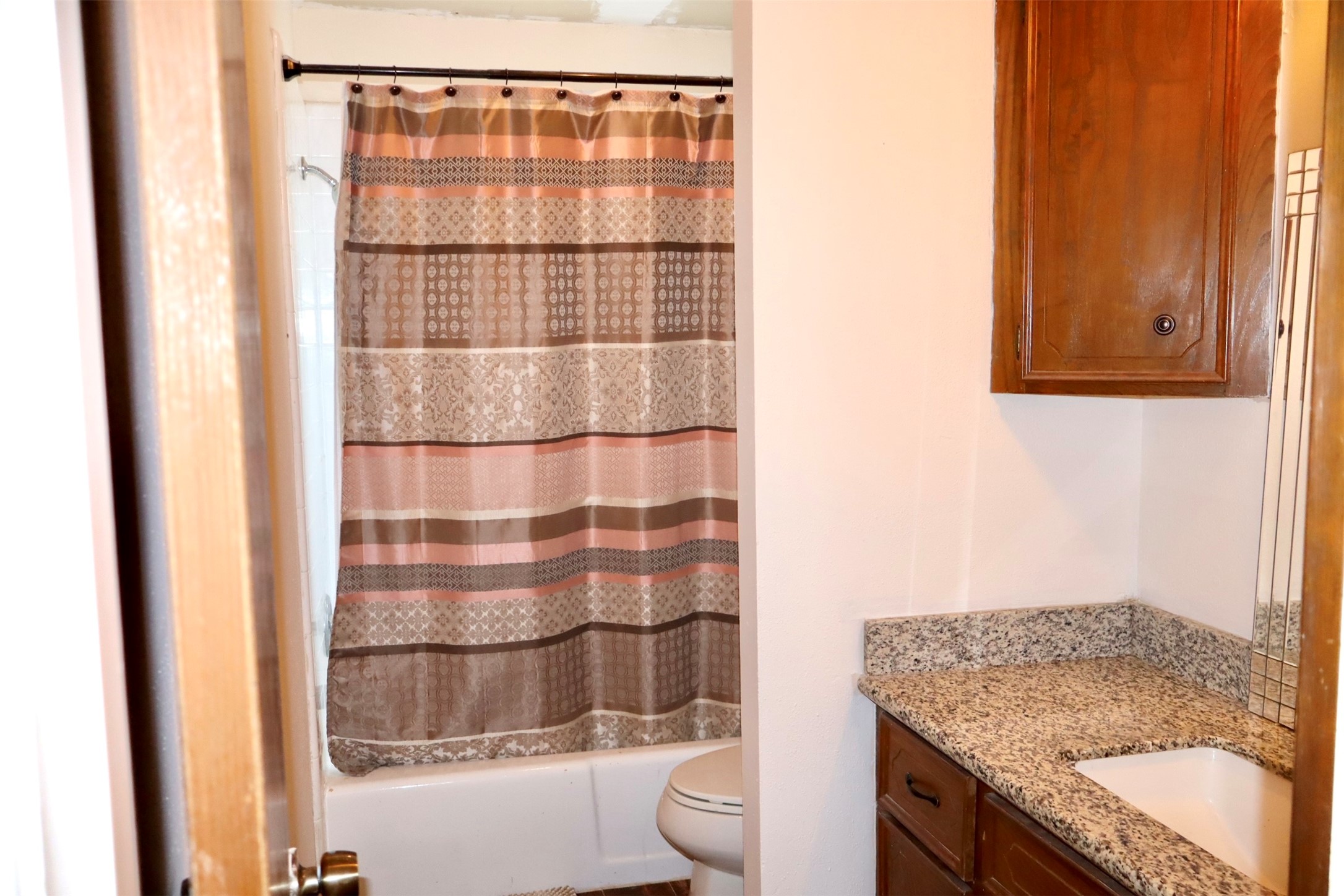 1108 Easy Street Rosenberg, TX 77471 - Photo 17 of 28 a bathroom with a granite countertop sink and a toilet