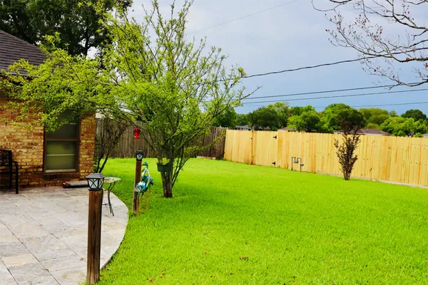 a view of yard with swimming pool and furniture