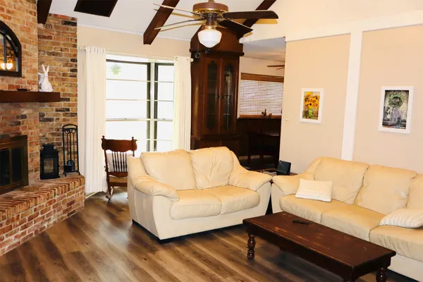 a living room with furniture a fireplace and a flat screen tv