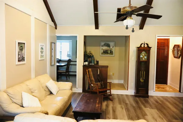 a living room with furniture and a wooden floor