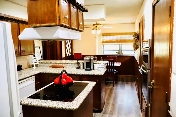 a kitchen with a sink a counter and cabinets