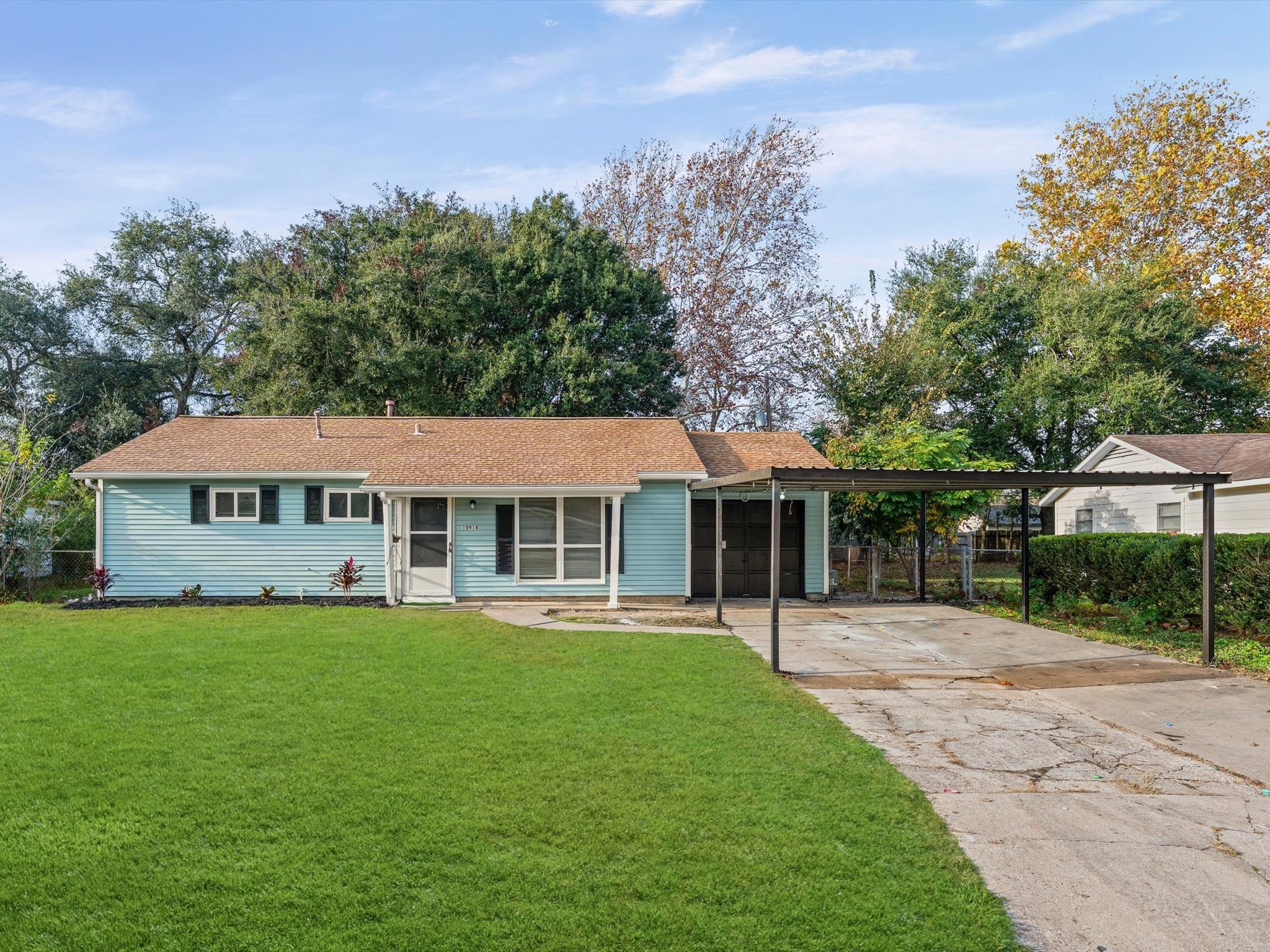 a view of a house with a yard and sitting area